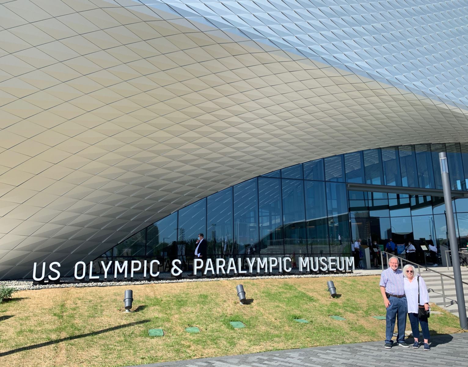 A group of people standing in front of a buildingDescription automatically generated