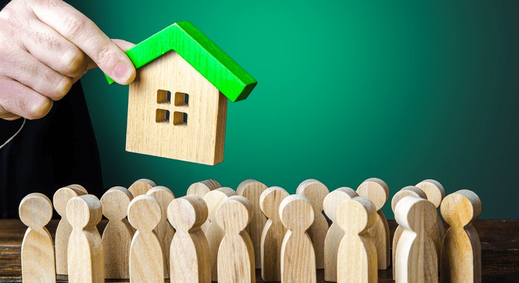 A hand holding a house over a group of peopleAI-generated content may be incorrect.