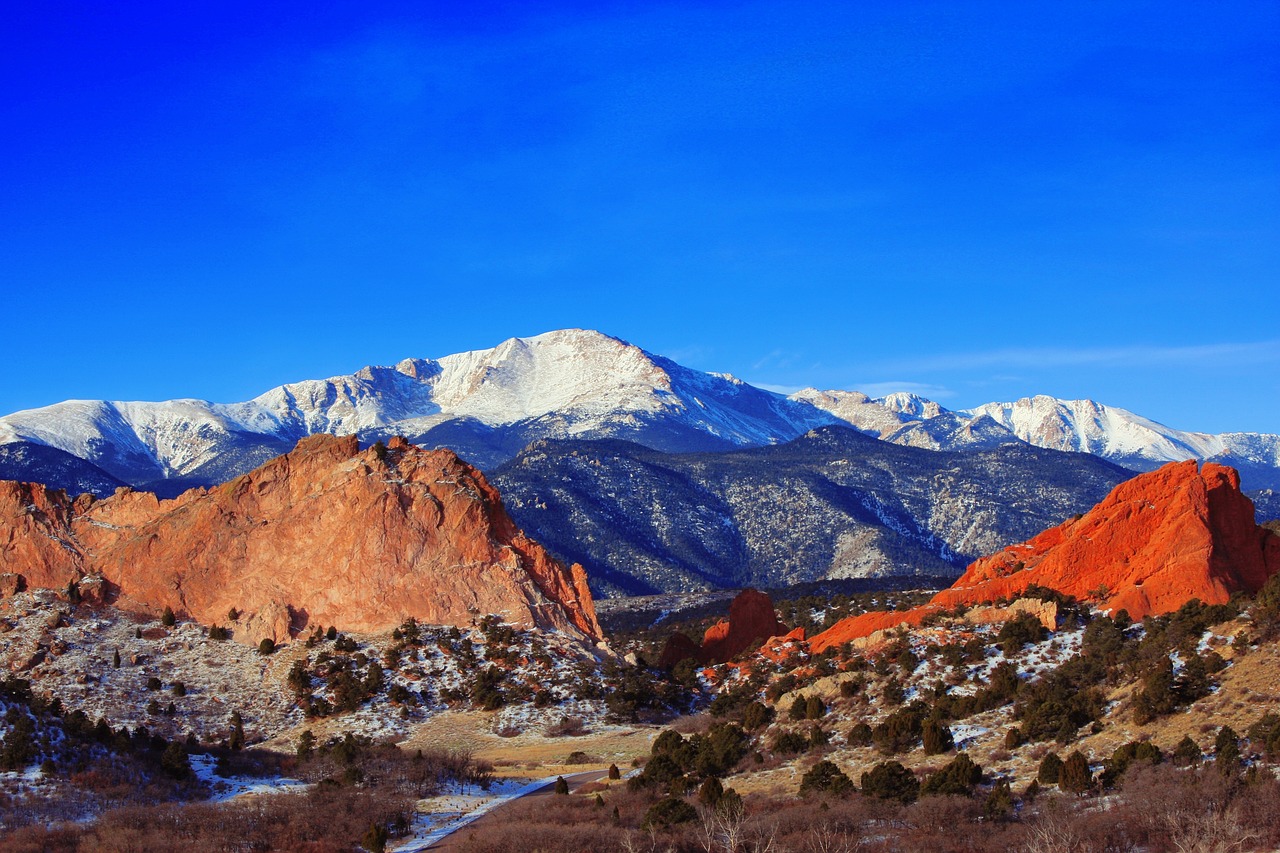 A mountain range with snow covered mountainsDescription automatically generated