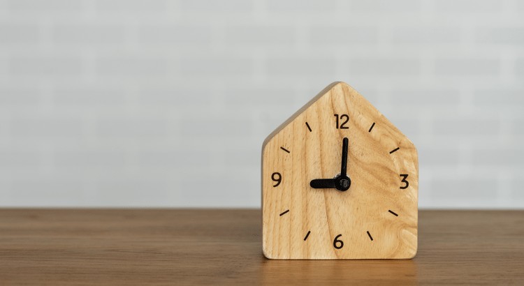 A wooden clock on a tableAI-generated content may be incorrect.